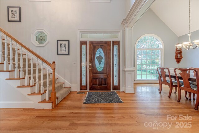 6024 Highview Rd, Weddington, NC 28104 - foyer featuring a high ceiling, stairs, light wood-style floors, a chandelier, and baseboards