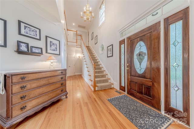 6024 Highview Rd, Weddington, NC 28104 - entrance foyer with stairs, a chandelier, light wood finished floors, ornamental molding, and baseboards