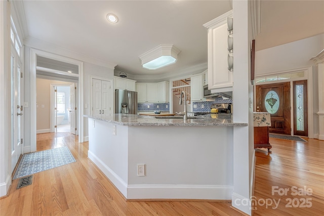 6024 Highview Rd, Weddington, NC 28104 - kitchen with stainless steel fridge with ice dispenser, a sink, light stone countertops, a peninsula, and tasteful backsplash