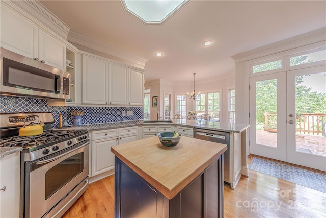 6024 Highview Rd, Weddington, NC 28104 - kitchen featuring appliances with stainless steel finishes, a peninsula, butcher block counters, ornamental molding, and white cabinetry