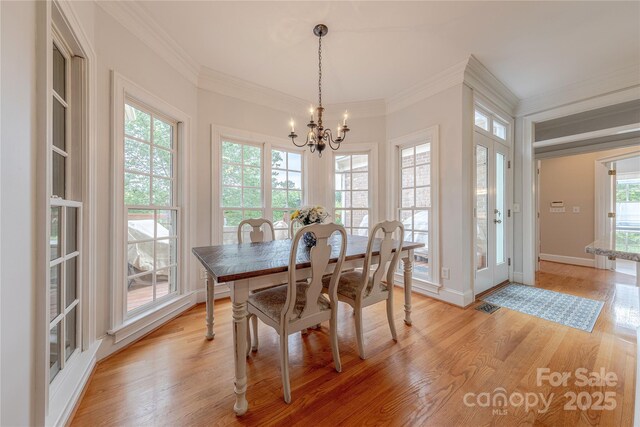 6024 Highview Rd, Weddington, NC 28104 - dining area featuring a chandelier, ornamental molding, light wood-style flooring, and baseboards