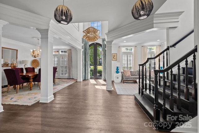 9625 Donna Ve Ln, Charlotte, NC 28277 - foyer entrance featuring decorative columns, dark wood-type flooring, ornamental molding, and a chandelier