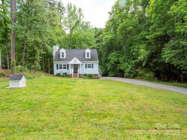 8905 Vagabond Rd, Mint Hill, NC 28227 - cape cod-style house with a shed, a chimney, a front yard, driveway, and an outbuilding