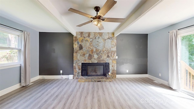 8905 Vagabond Rd, Mint Hill, NC 28227 - unfurnished living room featuring wood finished floors, beamed ceiling, a fireplace, ceiling fan, and baseboards