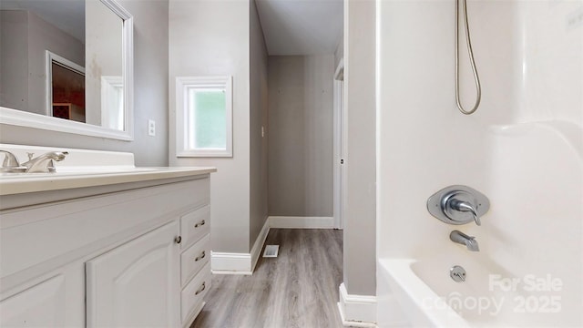 8905 Vagabond Rd, Mint Hill, NC 28227 - bathroom featuring wood finished floors, vanity, shower / washtub combination, and baseboards