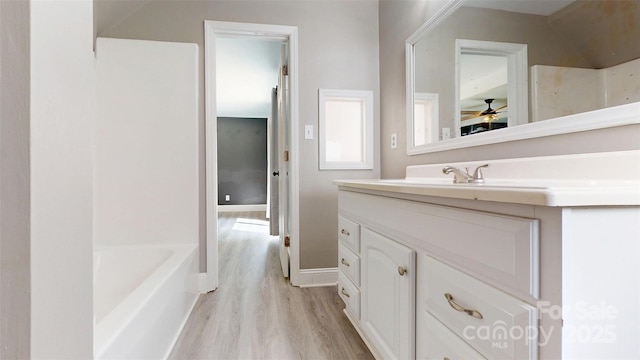 8905 Vagabond Rd, Mint Hill, NC 28227 - bathroom with wood finished floors, vanity, ceiling fan, baseboards, and a tub