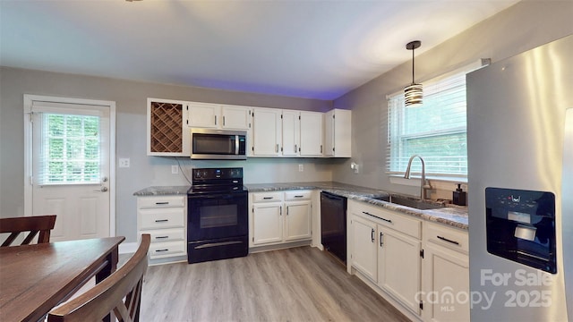 8905 Vagabond Rd, Mint Hill, NC 28227 - kitchen with black appliances, a sink, white cabinets, and light wood-style floors