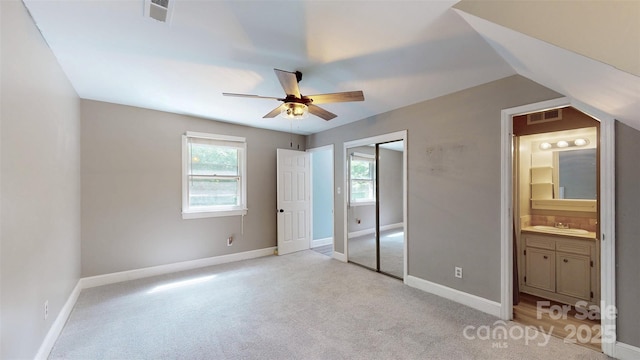 8905 Vagabond Rd, Mint Hill, NC 28227 - unfurnished bedroom with multiple windows, light carpet, a sink, and connected bathroom