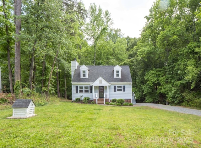 8905 Vagabond Rd, Mint Hill, NC 28227 - cape cod-style house with a front yard, a chimney, driveway, an outdoor structure, and a shed