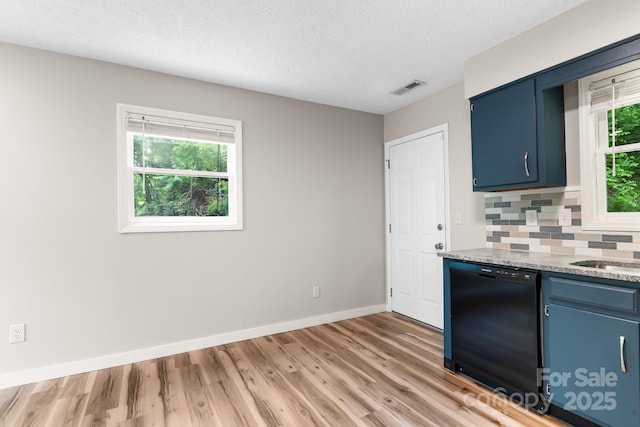 kitchen featuring dishwasher, blue cabinets, light wood-type flooring, backsplash, and baseboards
