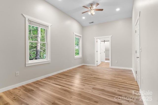 spare room featuring healthy amount of natural light, a ceiling fan, light wood-style flooring, recessed lighting, and baseboards