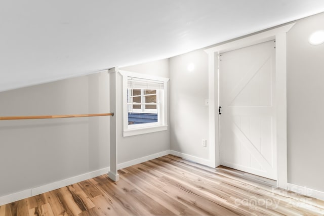 additional living space featuring light wood-style flooring and baseboards