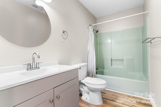 full bathroom with wood finished floors, toilet, vanity, and shower / bath combo