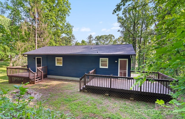 rear view of house with a deck and a shingled roof