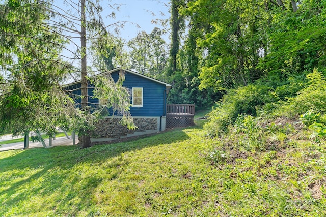 view of home's exterior with a yard and a deck
