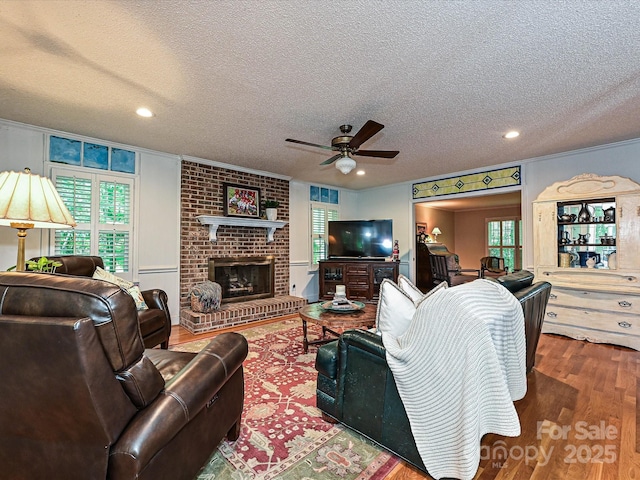 4951 Dayspring Dr, Mint Hill, NC 28227 - living room featuring ceiling fan, wood finished floors, a textured ceiling, recessed lighting, and a fireplace