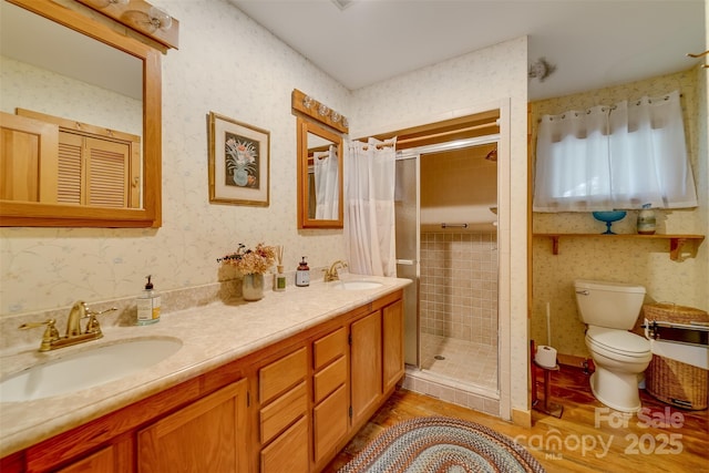 5271 Big Ridge Rd, Glenville, NC 28736 - full bathroom featuring wood finished floors, a stall shower, toilet, wallpapered walls, and double vanity