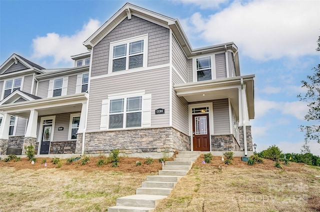 view of front of property with stone siding and a porch