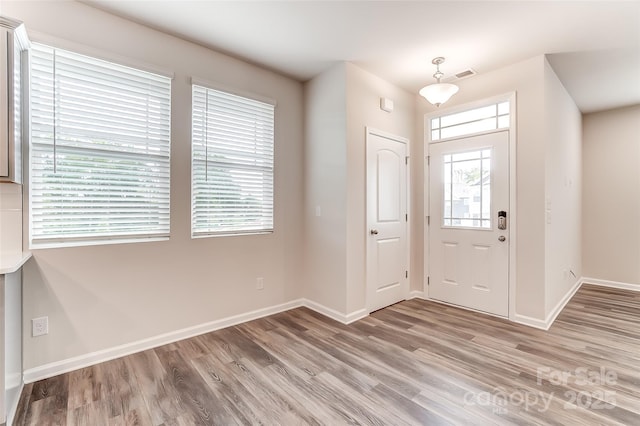 entrance foyer featuring light wood-style floors and baseboards