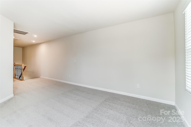 unfurnished living room featuring light carpet, baseboards, and recessed lighting