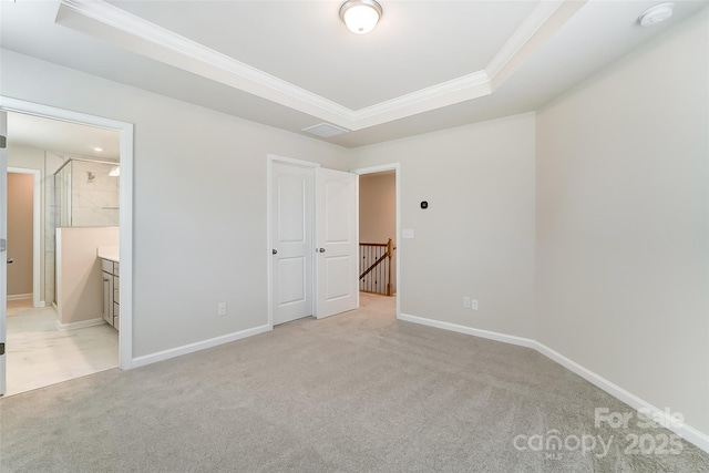 unfurnished bedroom featuring a raised ceiling, crown molding, light carpet, and baseboards