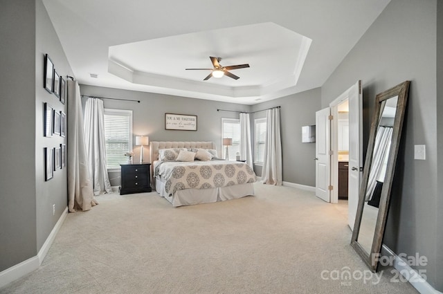 220 Forsythia Ln, Tega Cay, SC 29708 - bedroom featuring a tray ceiling, light colored carpet, multiple windows, and baseboards