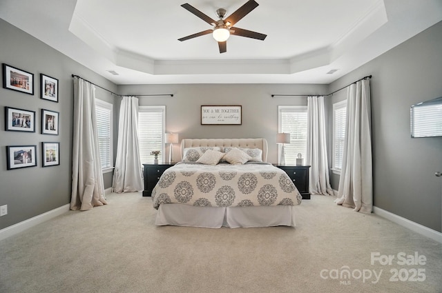 220 Forsythia Ln, Tega Cay, SC 29708 - carpeted bedroom with ornamental molding, a tray ceiling, multiple windows, ceiling fan, and baseboards