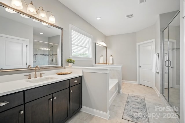220 Forsythia Ln, Tega Cay, SC 29708 - full bathroom featuring a shower stall, vanity, a garden tub, and baseboards