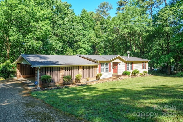 2310 Alexis Lucia Rd, Stanley, NC 28164 - single story home featuring gravel driveway, a carport, a front lawn, board and batten siding, and brick siding