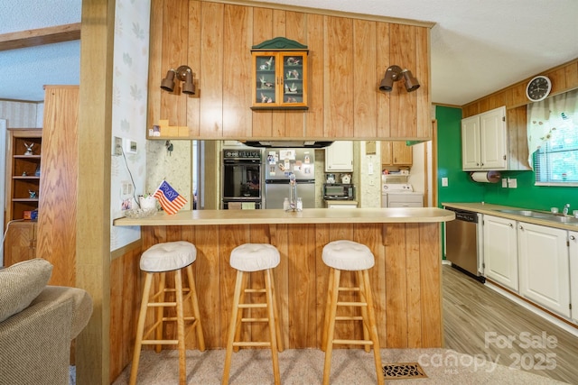 2310 Alexis Lucia Rd, Stanley, NC 28164 - kitchen with appliances with stainless steel finishes, washer / clothes dryer, a sink, white cabinetry, and light countertops