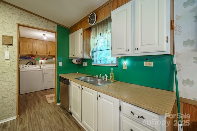 2310 Alexis Lucia Rd, Stanley, NC 28164 - kitchen featuring washing machine and dryer, stainless steel dishwasher, a sink, wood finished floors, and light countertops
