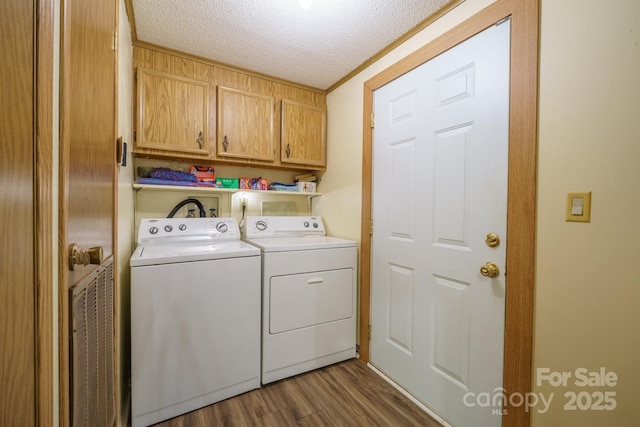 2310 Alexis Lucia Rd, Stanley, NC 28164 - clothes washing area with cabinet space, washing machine and dryer, a textured ceiling, and dark wood-style flooring
