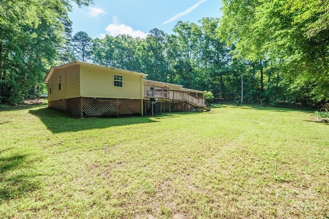 2310 Alexis Lucia Rd, Stanley, NC 28164 - view of green lawn with a wooden deck, stairs, and view of wooded area