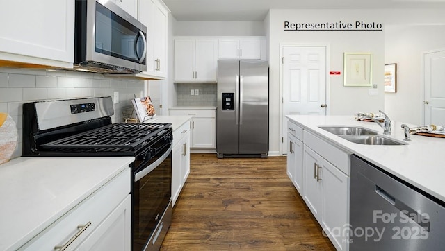 1415 5th Street Dr NE, Hickory, NC 28601 - kitchen with stainless steel appliances, a sink, light countertops, dark wood-type flooring, and white cabinetry