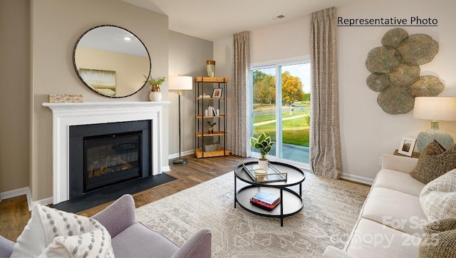 1415 5th Street Dr NE, Hickory, NC 28601 - living room featuring baseboards, wood finished floors, and a fireplace with flush hearth