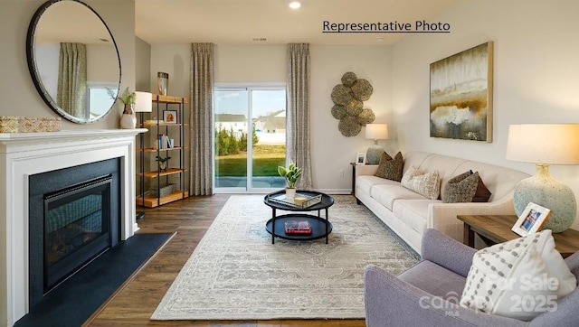 1415 5th Street Dr NE, Hickory, NC 28601 - living area featuring dark wood-type flooring, a glass covered fireplace, baseboards, and recessed lighting