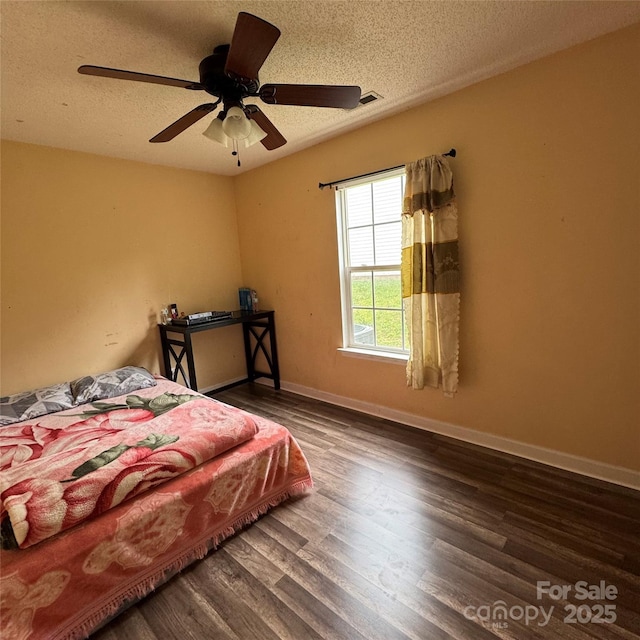 3012 Longspur Dr, Matthews, NC 28105 - bedroom featuring wood finished floors, a textured ceiling, baseboards, and a ceiling fan
