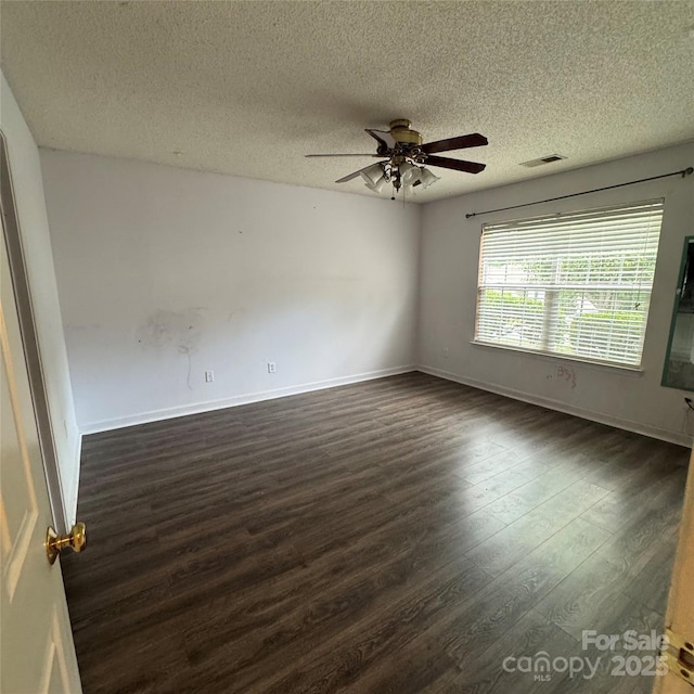 3012 Longspur Dr, Matthews, NC 28105 - spare room featuring dark wood finished floors, a ceiling fan, a textured ceiling, and baseboards