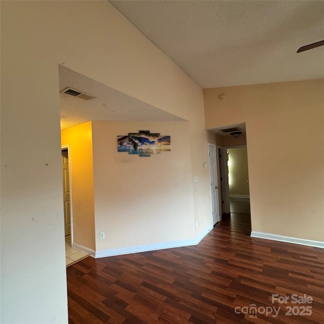3012 Longspur Dr, Matthews, NC 28105 - empty room with wood finished floors, high vaulted ceiling, a ceiling fan, baseboards, and a textured ceiling