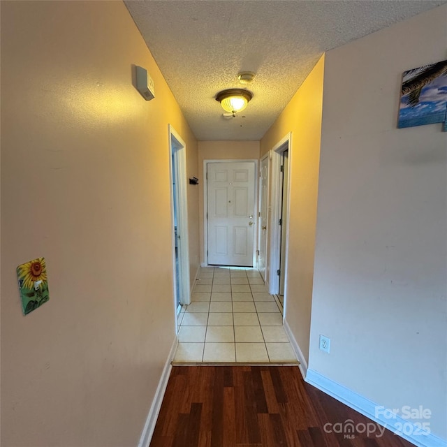 3012 Longspur Dr, Matthews, NC 28105 - hallway with a textured ceiling, light wood-style flooring, and baseboards