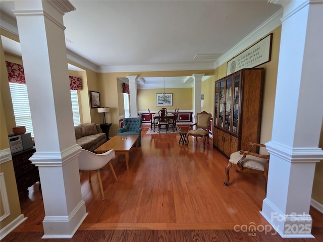 6017 Lowergate Dr, Waxhaw, NC 28173 - living room with ornate columns, plenty of natural light, wood finished floors, and crown molding