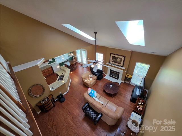 6017 Lowergate Dr, Waxhaw, NC 28173 - living area with a skylight, a tile fireplace, wood finished floors, healthy amount of natural light, and vaulted ceiling