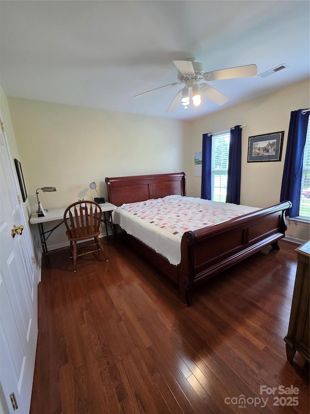 6017 Lowergate Dr, Waxhaw, NC 28173 - bedroom with dark wood-style flooring, multiple windows, and ceiling fan