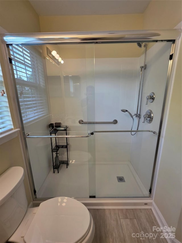 6017 Lowergate Dr, Waxhaw, NC 28173 - full bath with toilet, a shower stall, and wood finished floors