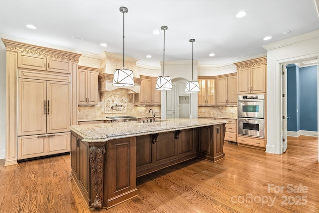 18843 Flat Shoals Dr, Cornelius, NC 28031 - kitchen featuring stainless steel appliances, a sink, a large island, backsplash, and light stone counters