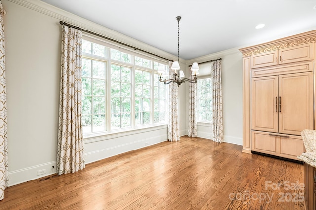 18843 Flat Shoals Dr, Cornelius, NC 28031 - unfurnished dining area with a chandelier, healthy amount of natural light, ornamental molding, and wood finished floors