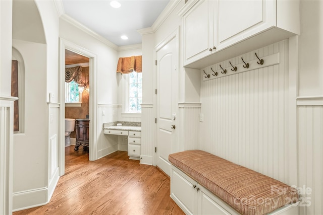 18843 Flat Shoals Dr, Cornelius, NC 28031 - mudroom with a wainscoted wall, light wood-style floors, recessed lighting, built in desk, and crown molding