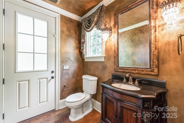 18843 Flat Shoals Dr, Cornelius, NC 28031 - half bath featuring wood finished floors, toilet, vanity, ornamental molding, and baseboards
