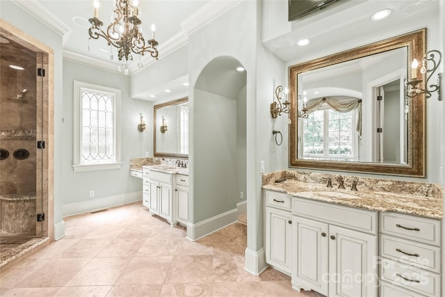 18843 Flat Shoals Dr, Cornelius, NC 28031 - full bath with ornamental molding, a shower stall, a chandelier, baseboards, and two vanities