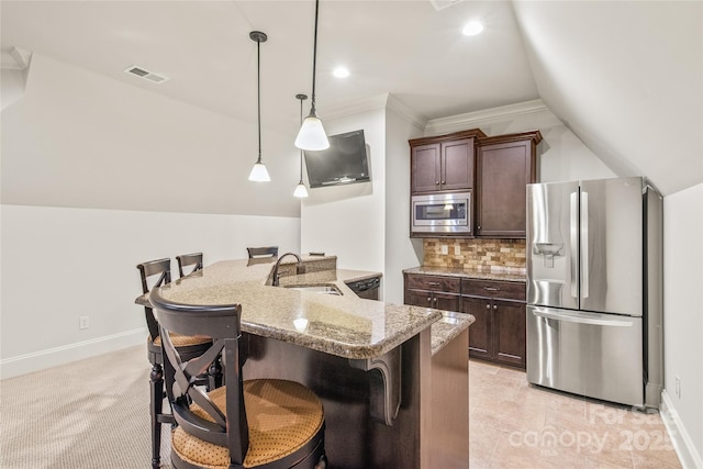 18843 Flat Shoals Dr, Cornelius, NC 28031 - kitchen with appliances with stainless steel finishes, a sink, a breakfast bar area, dark brown cabinets, and vaulted ceiling